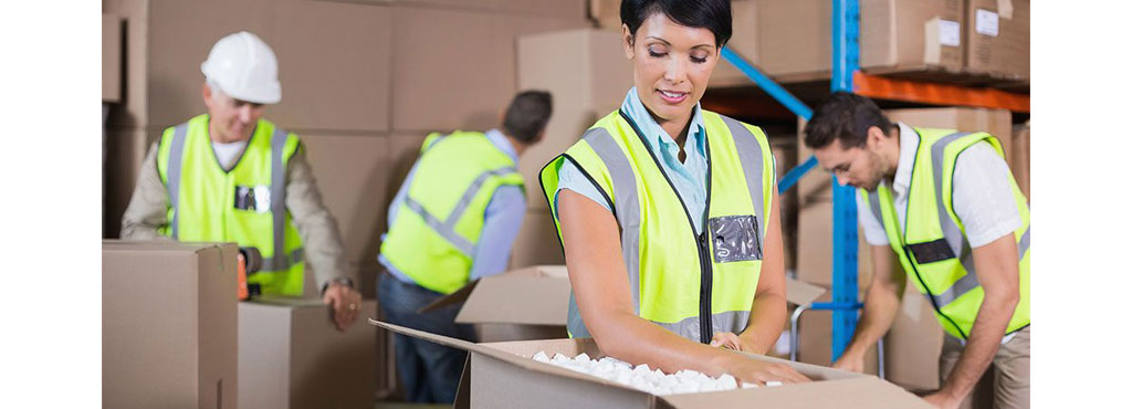 People in warehouse packing orders to ship EDI orders