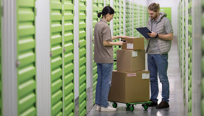 People at a logistics center fulfilling orders from a business that know what is order management software