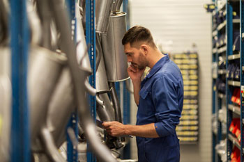 Person in parts warehouse using categorization as a method of how to organize parts inventory