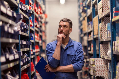 Warehouse worker wondering how to organize parts inventory more efficiently