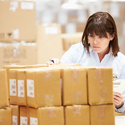 Person in warehouse preparing orders to be shipped via inventory control software