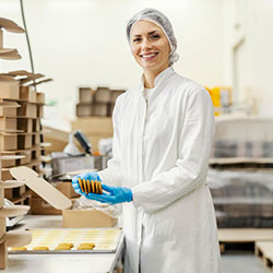 Person filling orders of baked goods at a food company using software for food distribution