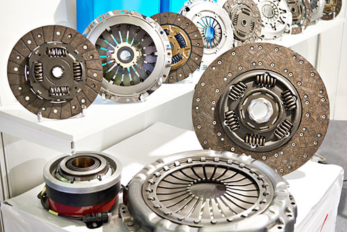Clutch discs and pressure plates parts on display in an automotive retail store with the auto parts supply chain