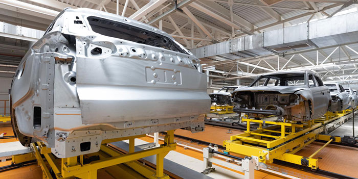 Car bodies on an assembly production line to represent the auto parts supply chain