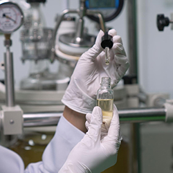 Hands of scientist testing cosmetic product in lab using cosmetic formulation software