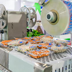 Food being packaged in a production line and managed with packaging manufacturing ERP