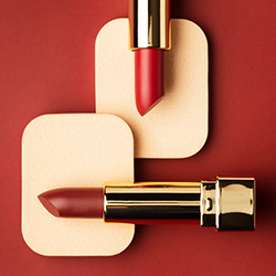 Red lipsticks over skin tone cards highlight the different shades produced with software for cosmetic formulation