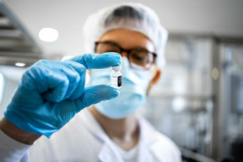 Pharmaceutical worker controlling the quality of vaccine production for distribution where inventory management for pharmaceutical distributors is important