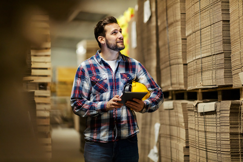 Warehouse worker looking at stock items uses Acctivate for automated inventory counting