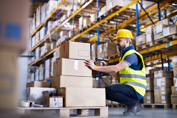 Worker scans boxes with mobile device with automated inventory counting for inventory management