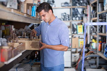 Worker organizing parts with spare parts management system