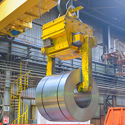 Crane loading metal in steel warehouse
