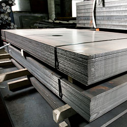 Stacks of stainless steel metal sheets in warehouse