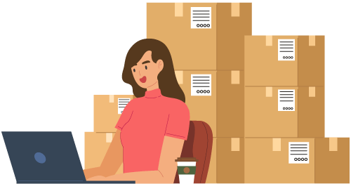 Person on laptop with stacks of boxes in the background representing using inventory software to automate warehouse tasks