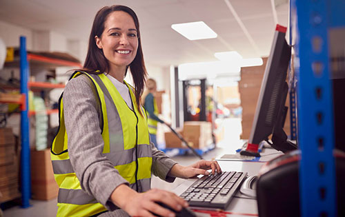 Person in warehouse at computer who could benefit from QuickBooks sync with Acctivate Inventory Software