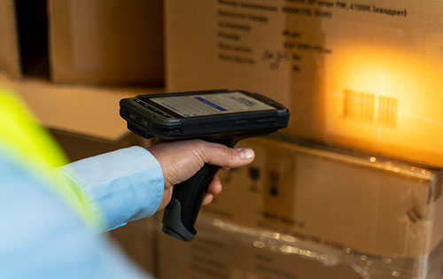 Mobile picking with Acctivate inventory and order management software A barcode on a box being scanned with a mobile device for mobile picking orders