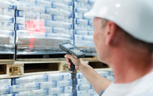 Mobile warehouse management with Acctivate Inventory Software delivers efficiency for picking, receiving, transferring, and counting inventory. Person in warehouse scanning product barcode of inventory on shelf using a mobile barcoding device